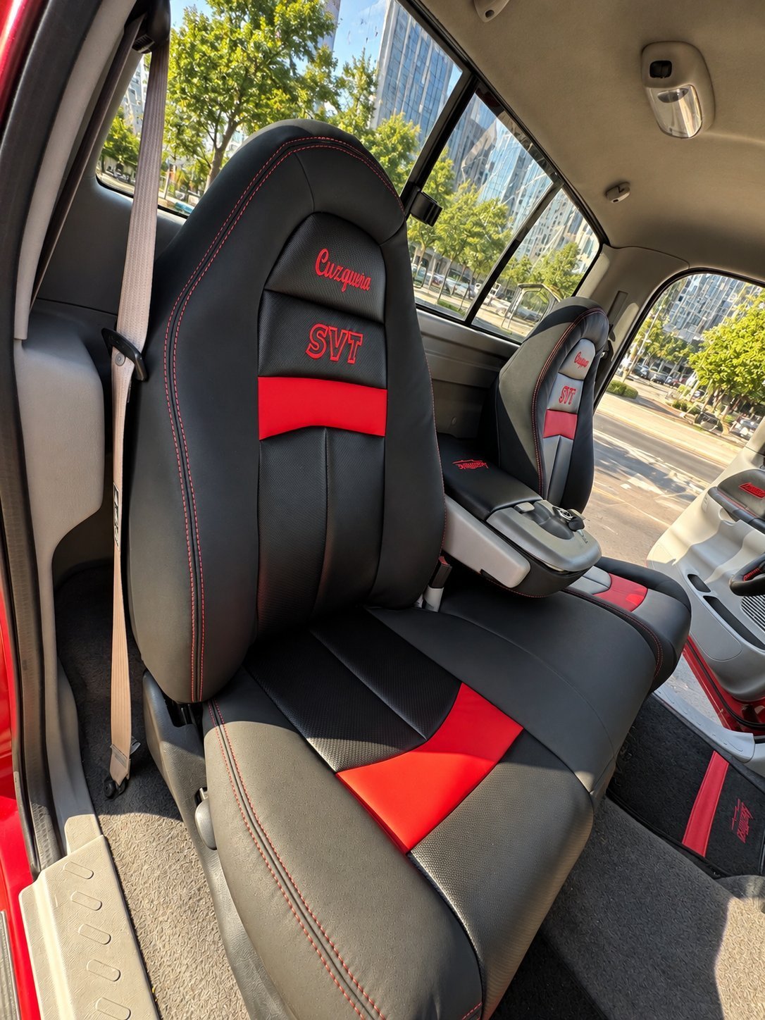 Custom black and red leather truck seat with red stitching and embroidered SVT logo