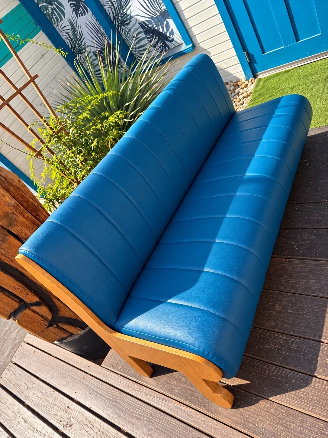 Blue channel-stitched vinyl bench with natural wood base