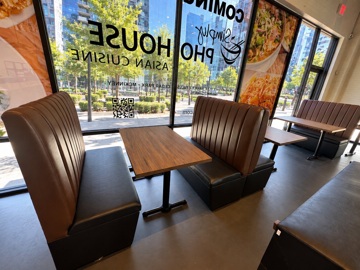 Brown channel-tufted leather booths with wood-top tables