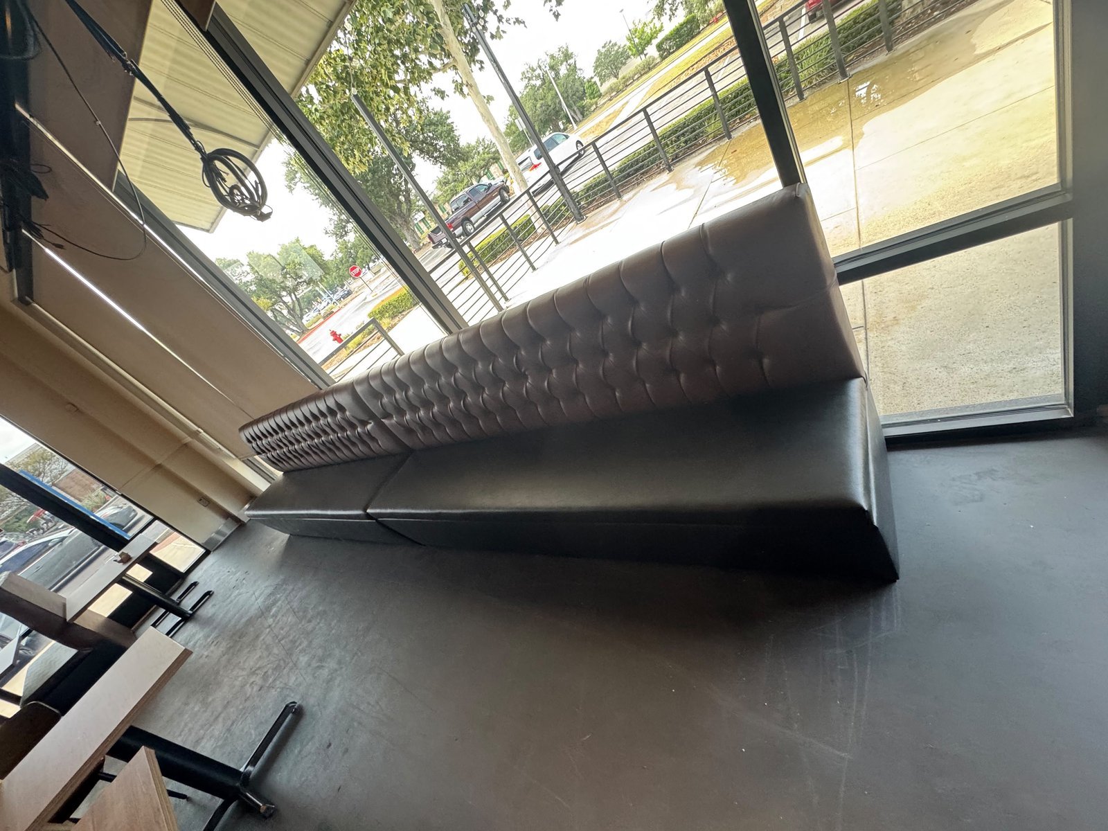 Cognac leather curved booth restaurant with live-edge wood table